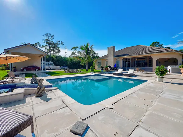 a view of swimming pool with outdoor seating