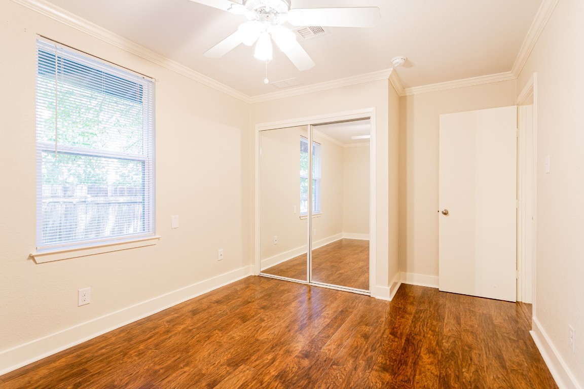 1909 Morrow Street, Unit B Austin, TX 78757 - Photo 11 of 16 an empty room with wooden floor and windows