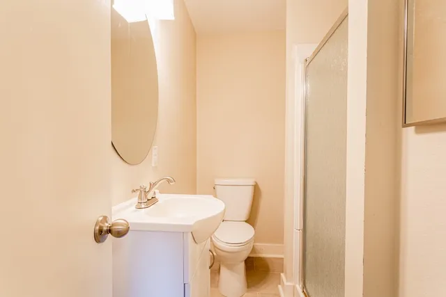 a bathroom with a sink mirror and toilet