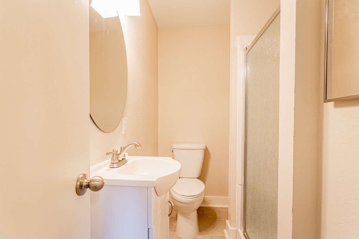 1909 Morrow Street, Unit B Austin, TX 78757 - Photo 15 of 16 a bathroom with a sink mirror and toilet