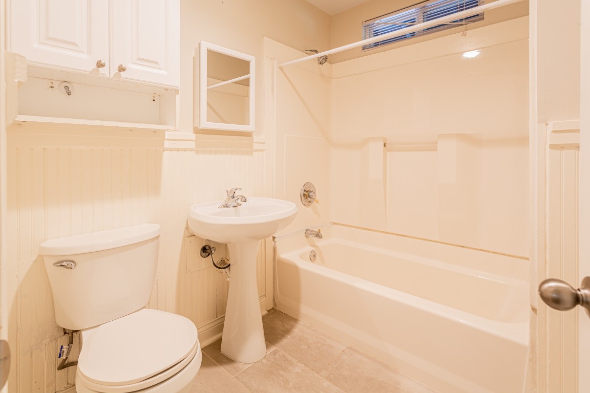 1909 Morrow Street, Unit B Austin, TX 78757 - Photo 16 of 16 a white toilet sitting next to a bath tub