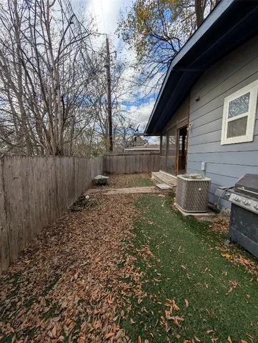 a backyard of a house with barbeque oven