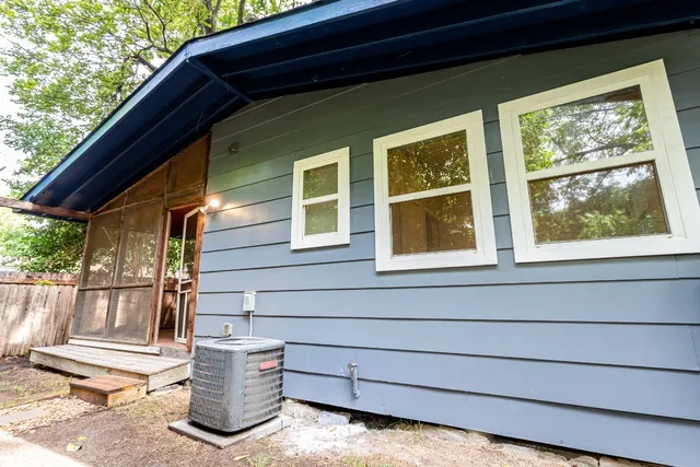 a view of house with backyard and outdoor seating