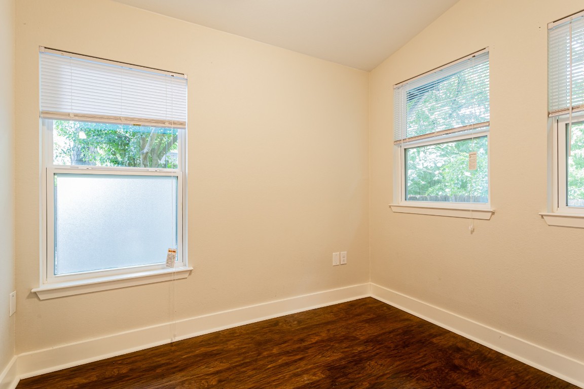 1909 Morrow Street, Unit B Austin, TX 78757 - Photo 6 of 16 an empty room with wooden floor and windows