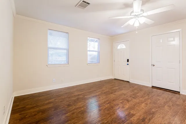 wooden floor in an empty room with a window
