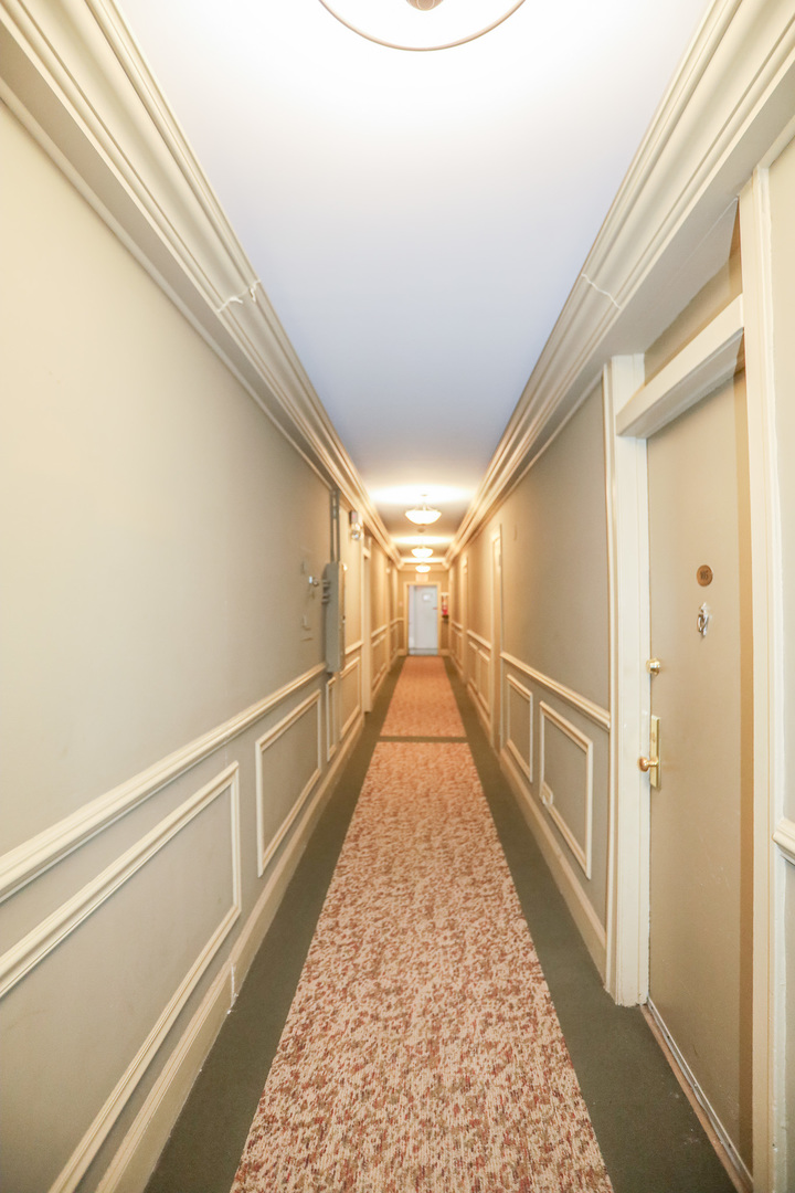 5326 South Cornell Avenue, Unit 406 Chicago, IL 60615 - Photo 12 of 12 a view of a hallway with wooden floor and staircase