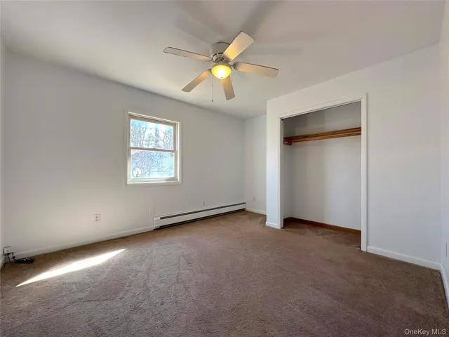a bathroom with a toilet sink vanity and mirror