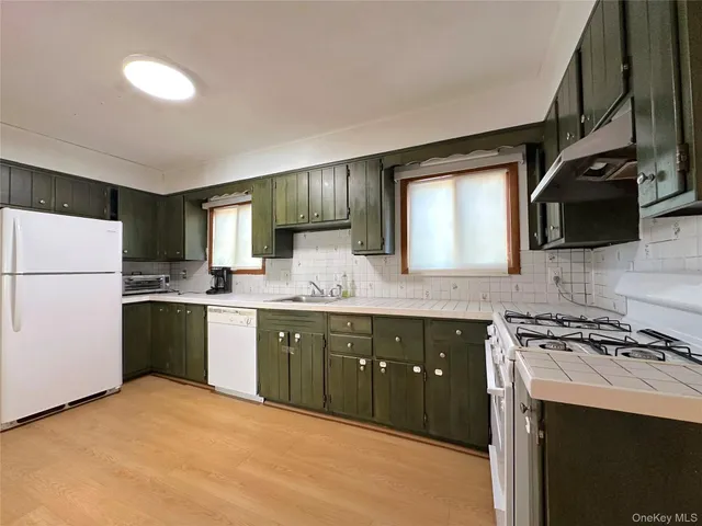 a kitchen with a sink cabinets and appliances
