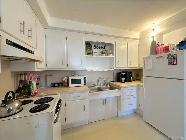 a kitchen with a sink a stove and cabinets