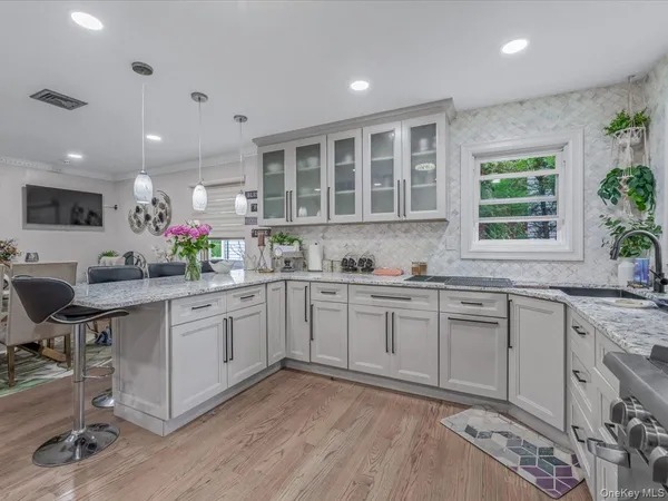 a kitchen with granite countertop a sink cabinets and window