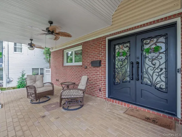 a view of a patio with table and chairs and potted plants