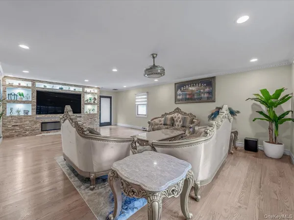 a large white kitchen with a large window and stainless steel appliances