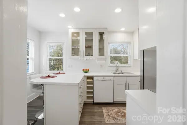 a kitchen with sink stove and refrigerator