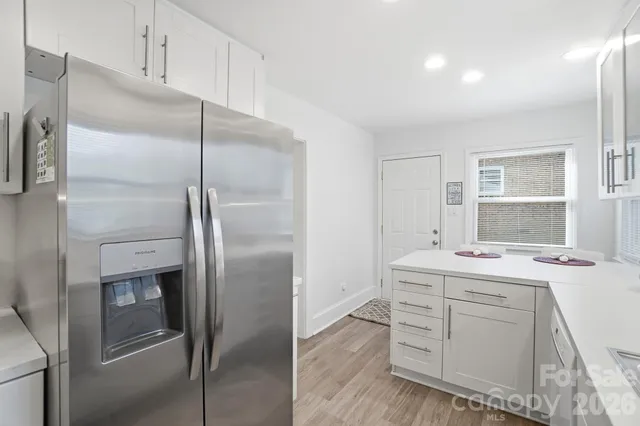 a kitchen with a refrigerator sink stove and cabinets