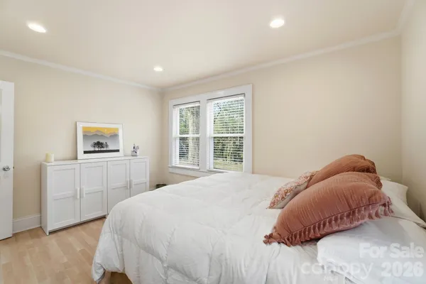 a bedroom with a large bed and a window