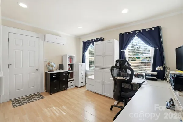 a room with a bed and a flat tv screen