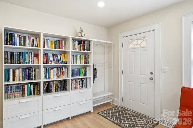 a room with a book shelf and a window