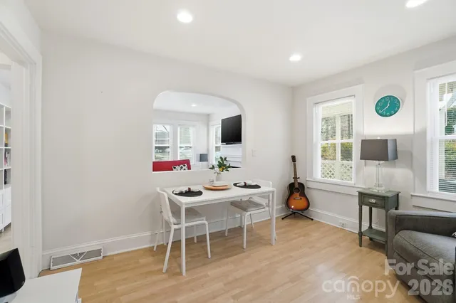 a view of a dining room with furniture and a window