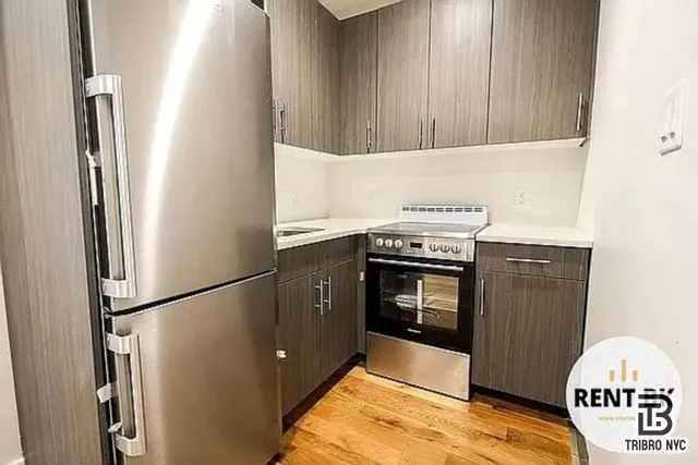 a kitchen with granite countertop a stove and a refrigerator