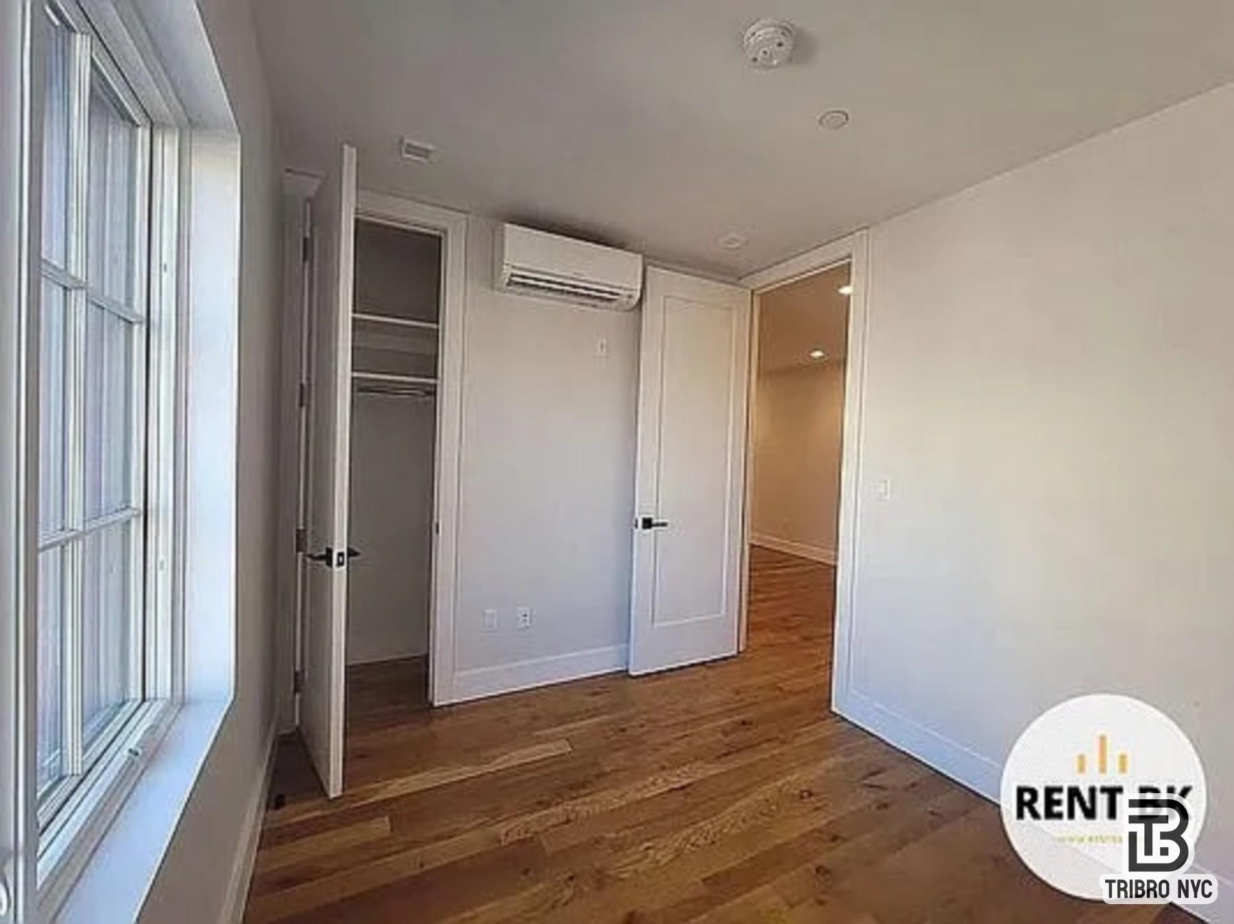 234 North 12th Street, Unit 4F Brooklyn, NY 11211 - Photo 4 of 7 a view of an empty room with wooden floor and a window