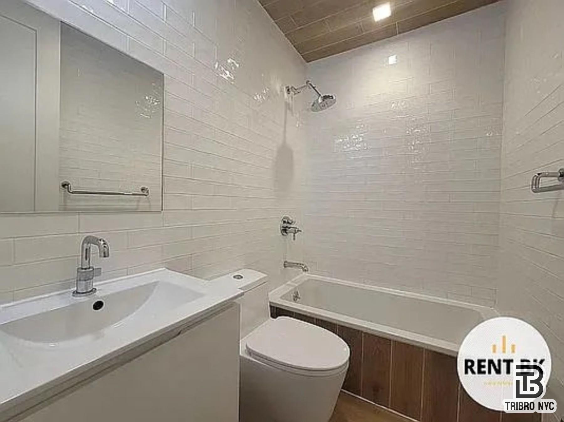 234 North 12th Street, Unit 4F Brooklyn, NY 11211 - Photo 6 of 7 a bathroom with a sink a toilet and shower