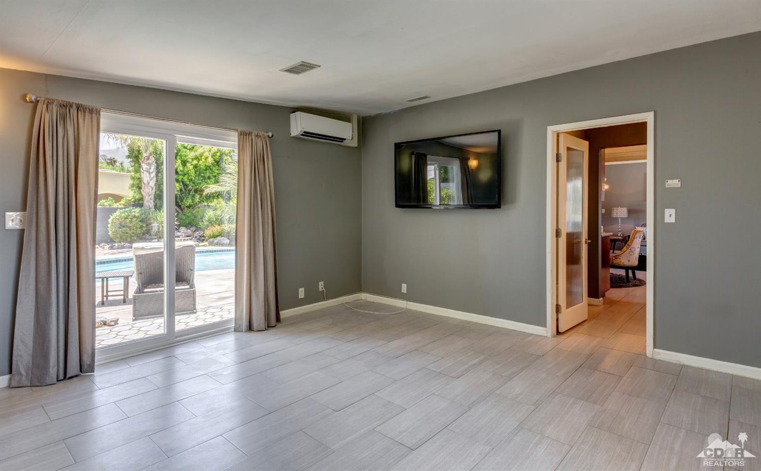 1950 North Magnolia Road Palm Springs, CA 92262 - Photo 14 of 36 wooden floor in an empty room with a window