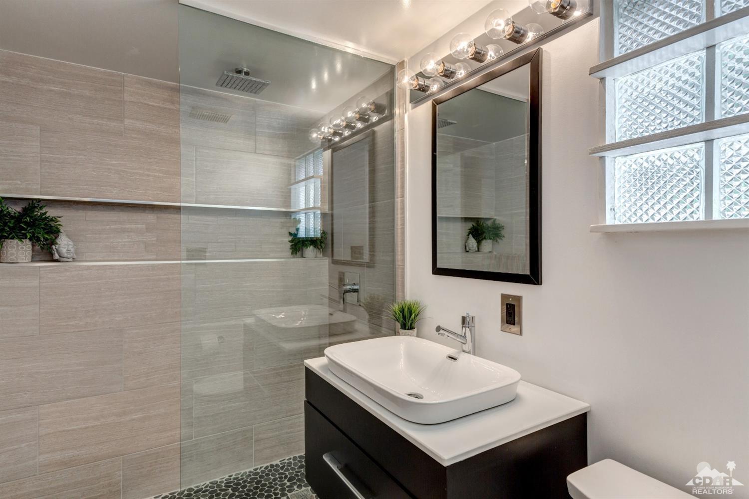 1950 North Magnolia Road Palm Springs, CA 92262 - Photo 15 of 36 a bathroom with a sink mirror and a shower