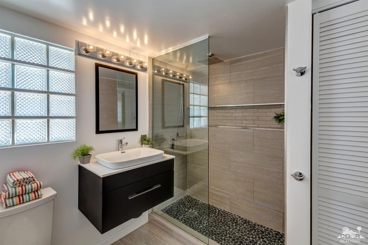 1950 North Magnolia Road Palm Springs, CA 92262 - Photo 18 of 36 a bathroom with a sink mirror and shower