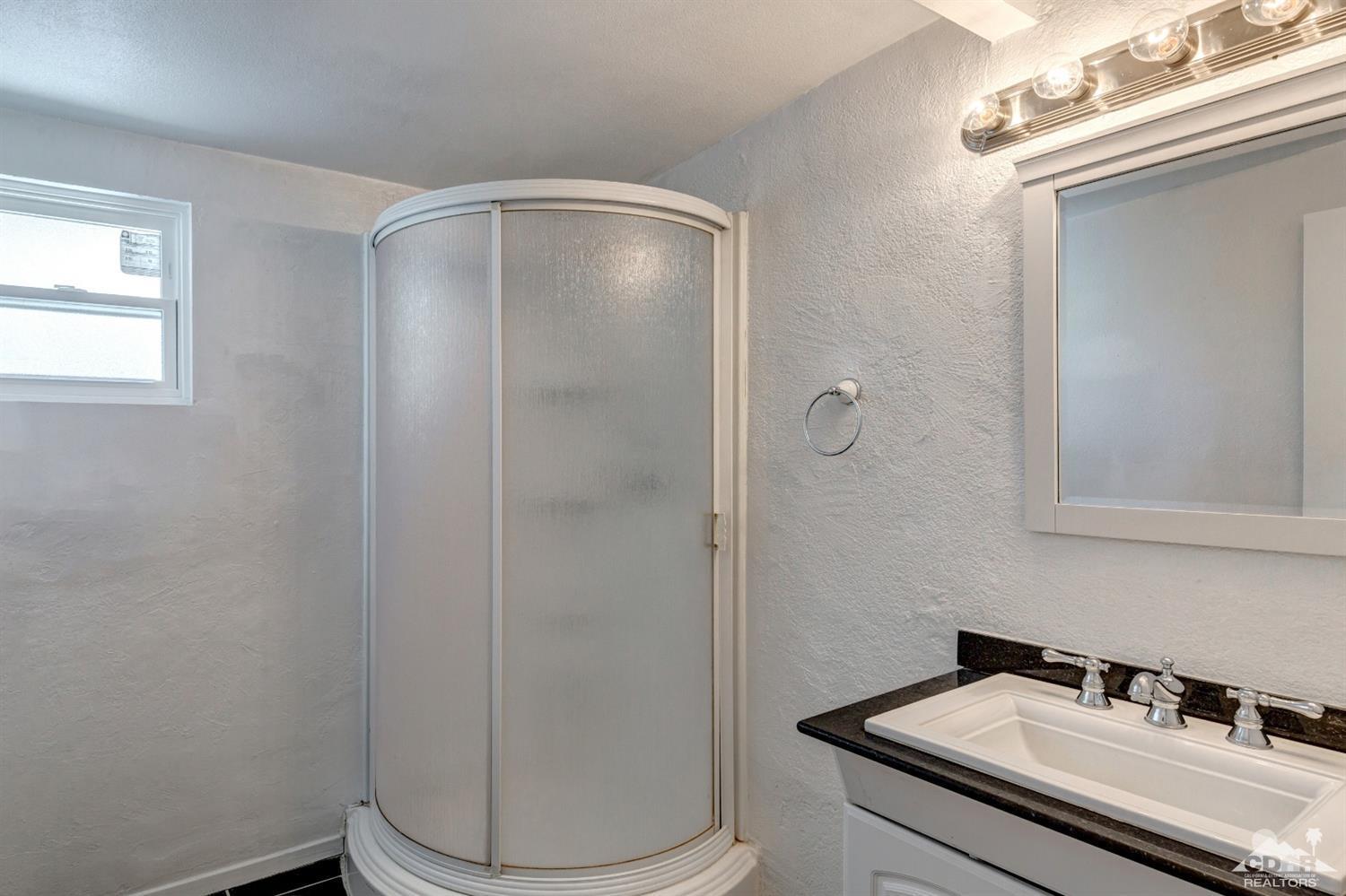 1950 North Magnolia Road Palm Springs, CA 92262 - Photo 21 of 36 a bathroom with a sink a toilet and shower