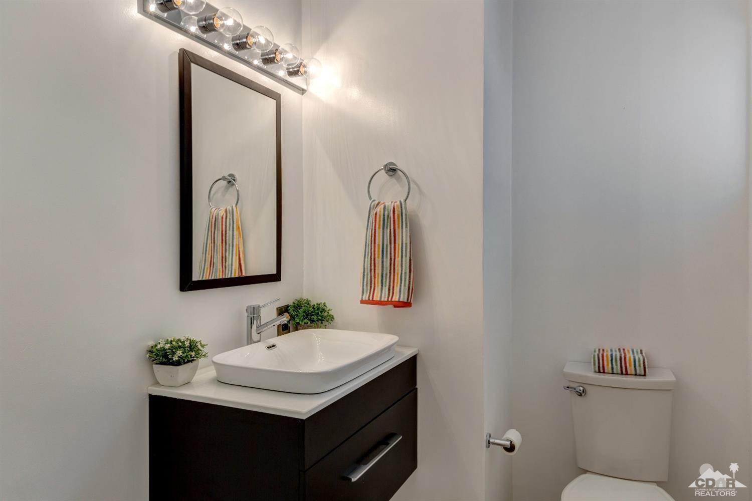 1950 North Magnolia Road Palm Springs, CA 92262 - Photo 23 of 36 a bathroom with a granite countertop sink a toilet and a mirror