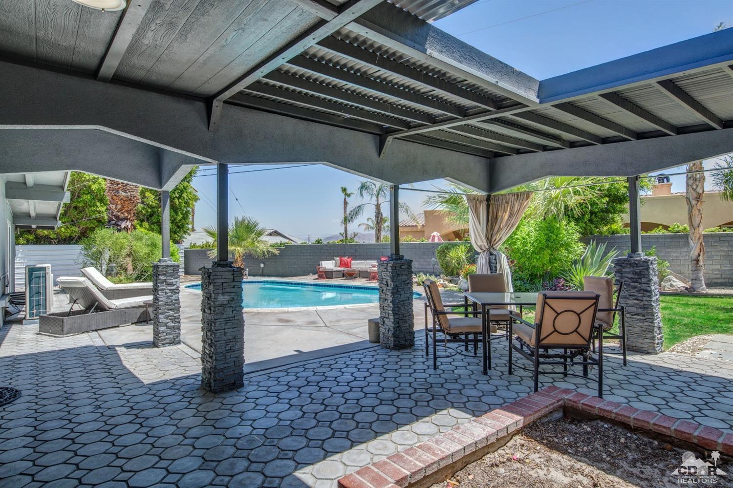 1950 North Magnolia Road Palm Springs, CA 92262 - Photo 24 of 36 a view of a patio with table and chairs potted plants