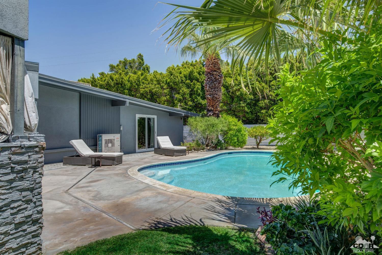 1950 North Magnolia Road Palm Springs, CA 92262 - Photo 26 of 36 a view of a backyard with chairs potted plants and large tree