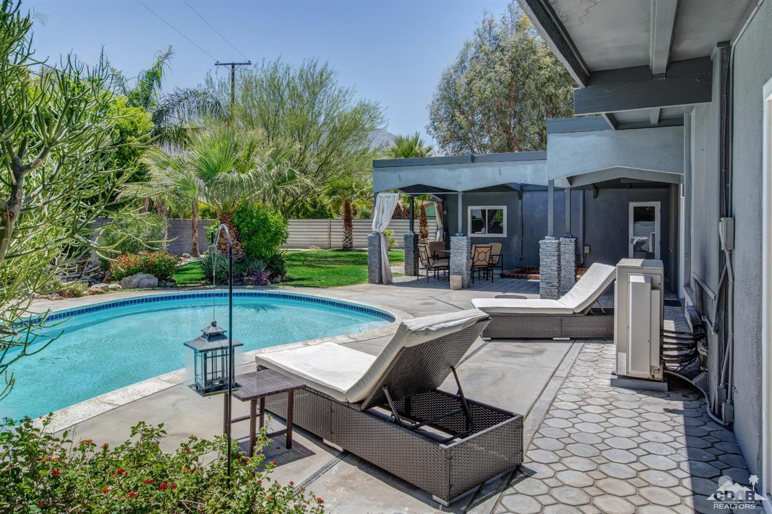 1950 North Magnolia Road Palm Springs, CA 92262 - Photo 29 of 36 a view of a house with backyard sitting area and garden