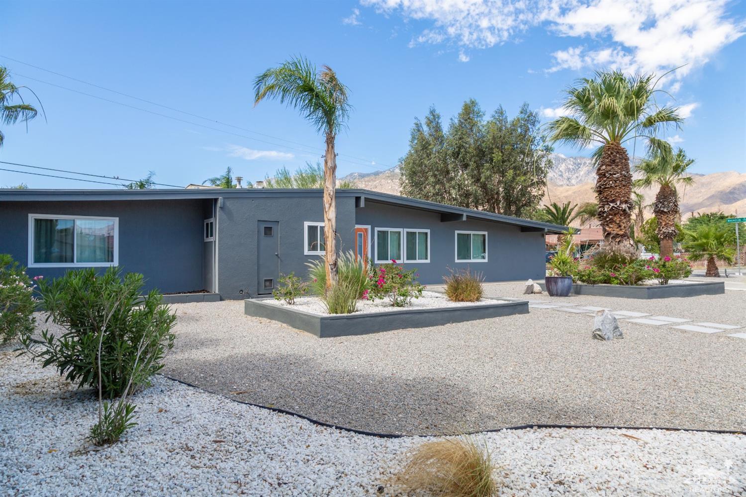 1950 North Magnolia Road Palm Springs, CA 92262 - Photo 33 of 36 a front view of a house with garden and parking
