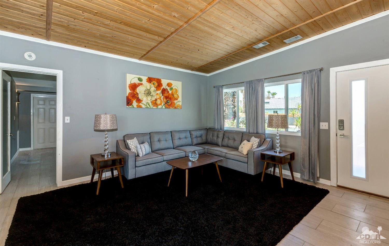 1950 North Magnolia Road Palm Springs, CA 92262 - Photo 6 of 36 a living room with furniture and a flat screen tv