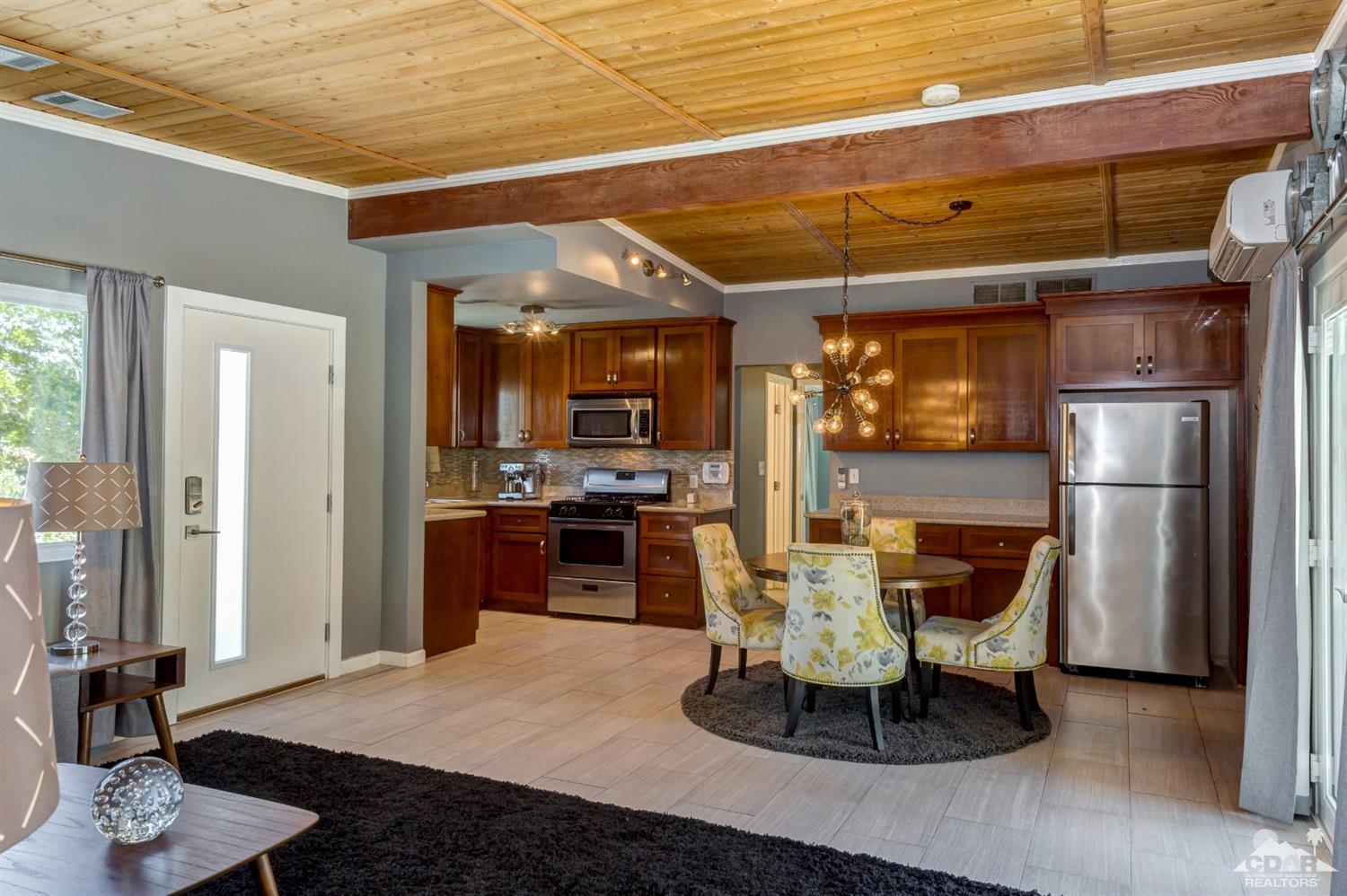 1950 North Magnolia Road Palm Springs, CA 92262 - Photo 7 of 36 a dining room with furniture and a kitchen view