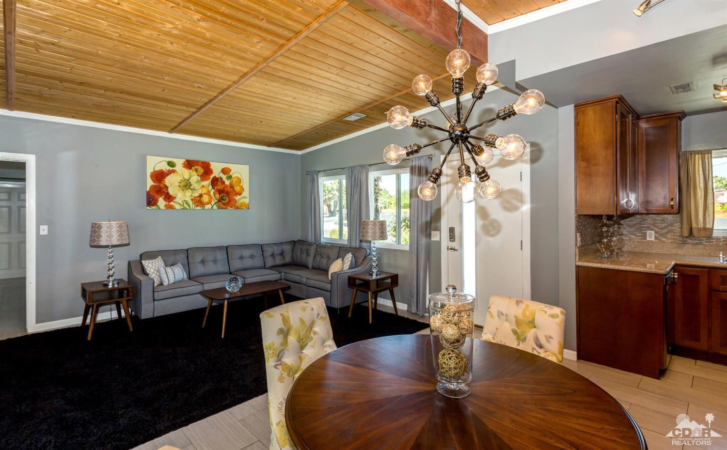 1950 North Magnolia Road Palm Springs, CA 92262 - Photo 8 of 36 a living room with furniture and a chandelier