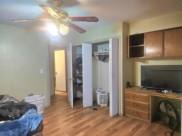 a view of workspace with wooden floor and ceiling fan