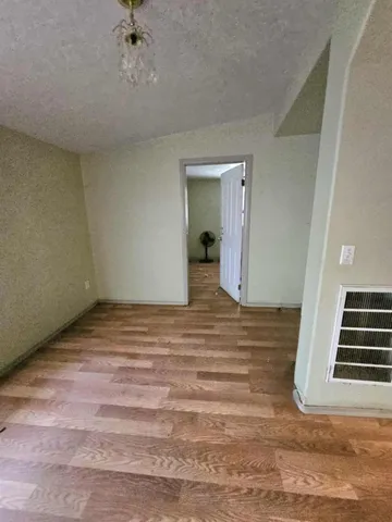 a view of a room with wooden floor and staircase