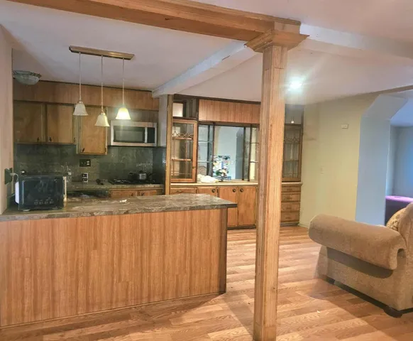a spacious bathroom with a tub and mirror