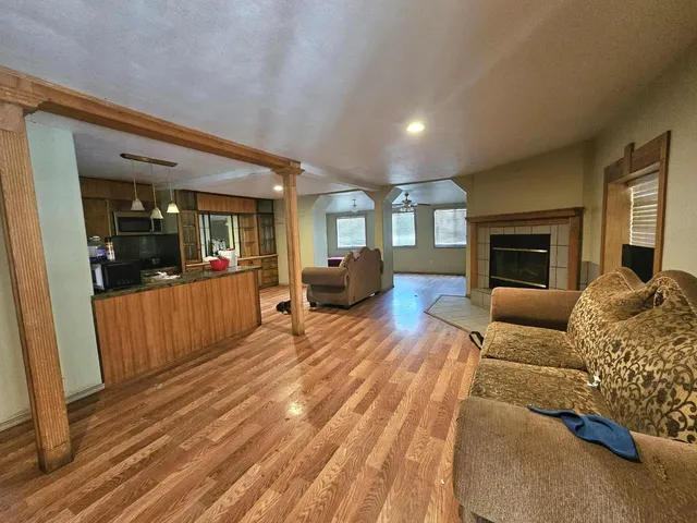 a spacious bedroom with a large bed a couch and dresser