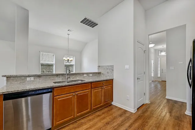 a bathroom with a granite countertop sink a mirror and shower