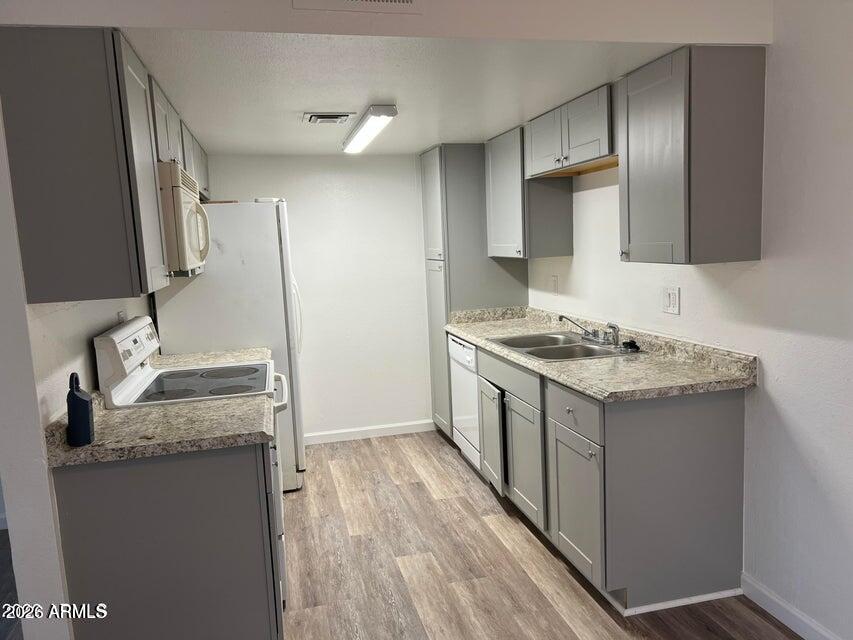 860 East Brown Road, Unit 53 Mesa, AZ 85203 - Photo 2 of 14 a kitchen with a sink stove and cabinets