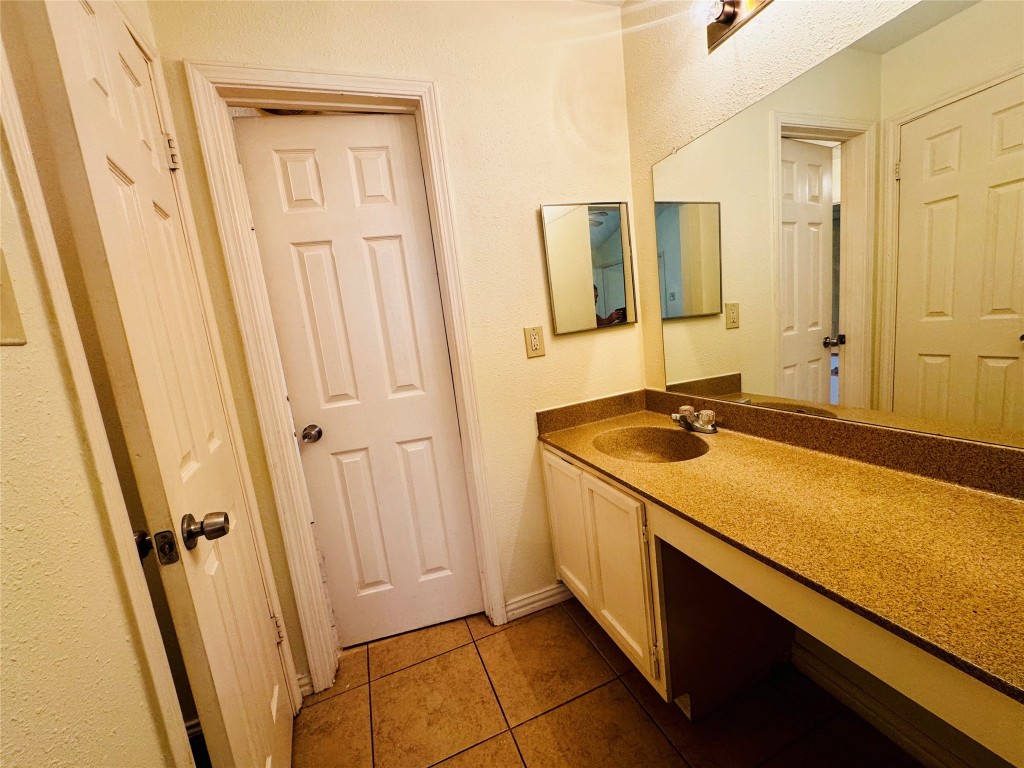 17118 Amber Ridge Drive Sugar Land, TX 77498 - Photo 18 of 20 a bathroom with a sink and a mirror