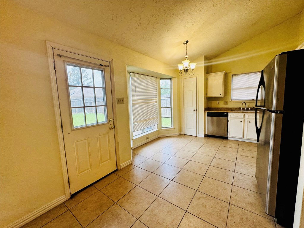 17118 Amber Ridge Drive Sugar Land, TX 77498 - Photo 10 of 20 a view of a kitchen with a sink and a refrigerator