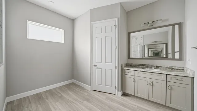 a bathroom with a sink a mirror and vanity