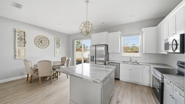 a large kitchen with a table and chairs