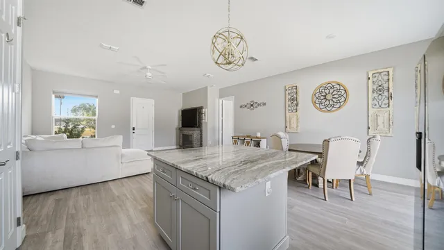 a view of kitchen with granite countertop lots of counter top space