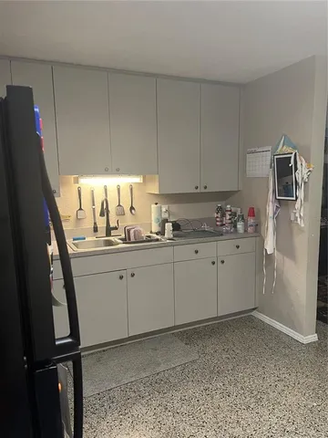 a utility room with cabinets washer and dryer