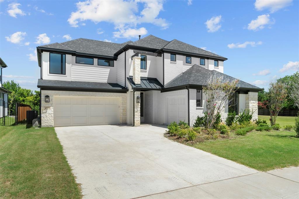 The property features a contemporary exterior with white brick, dark-framed windows, and a black roof